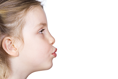 Child exhaling through pursed lips